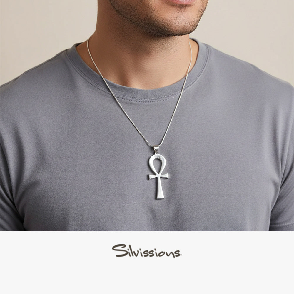 Man wearing a silver Ankh pendant necklace on a plain background with 'Silvissions' branding.