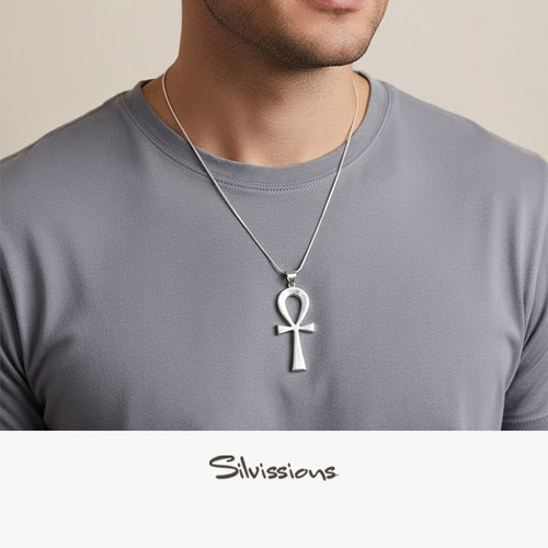 Man wearing a silver Ankh pendant necklace on a plain background with 'Silvissions' branding.