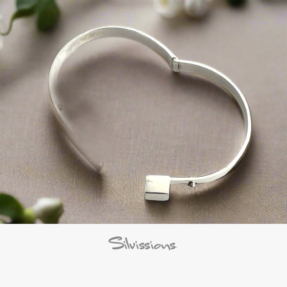 Silver bracelet on a beige surface with 'Silvissions' branding.