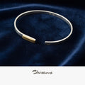 Handmade Sterling Silver Bangle Bracelet with a Gold Accent