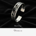 Silver bracelet with black onyx stones on a dark background, featuring the brand 'Silvissions'.