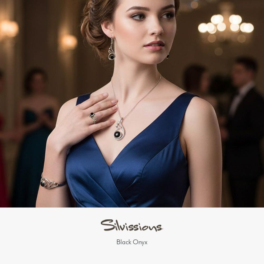 Woman in a blue dress wearing jewelry with 'Silvissions' branding.