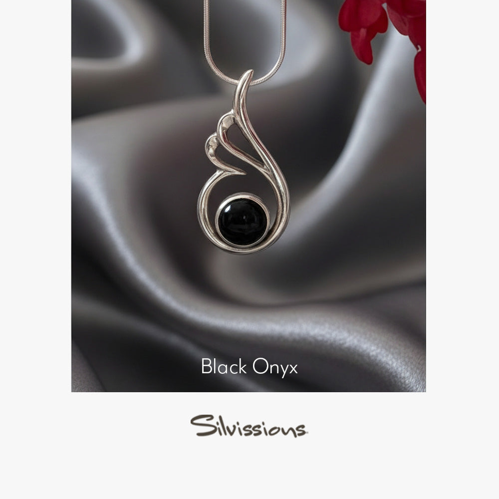 Sterling Silver pendant with black onyx stone on a blurred background
