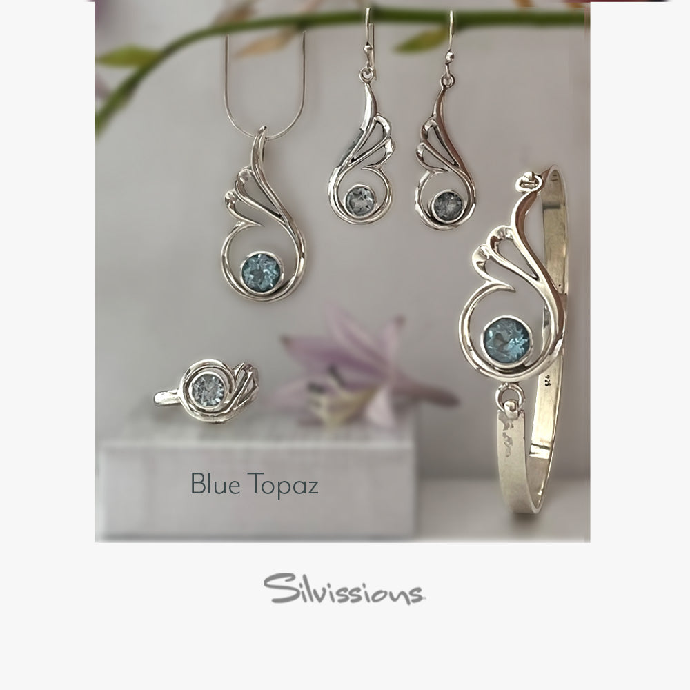 Silver jewelry set with blue gemstones on a white stand, featuring the brand 'Silvissions'.