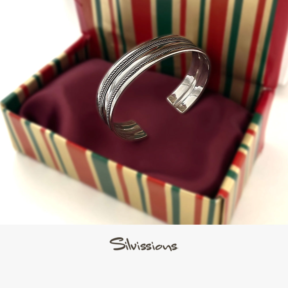 Silver bracelet in a colorful hand wrapped striped box with 'Silvissions' branding.