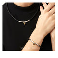 Person wearing a black choker and bracelet with a triangle design, branded 'SILIVISIONS'.