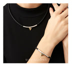 Person wearing a black choker and bracelet with a triangle design, branded 'SILIVISIONS'.