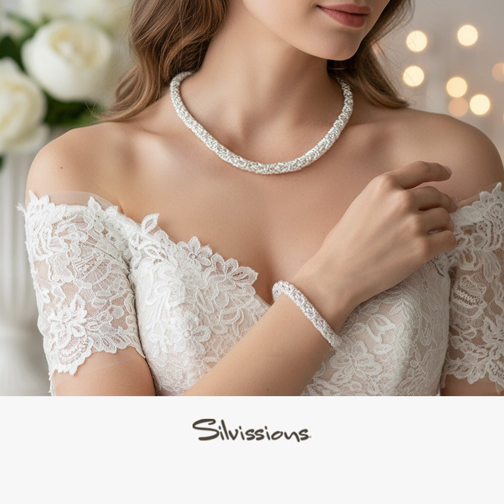 Woman wearing a white lace dress with jewelry, with 'Silvissions' branding.