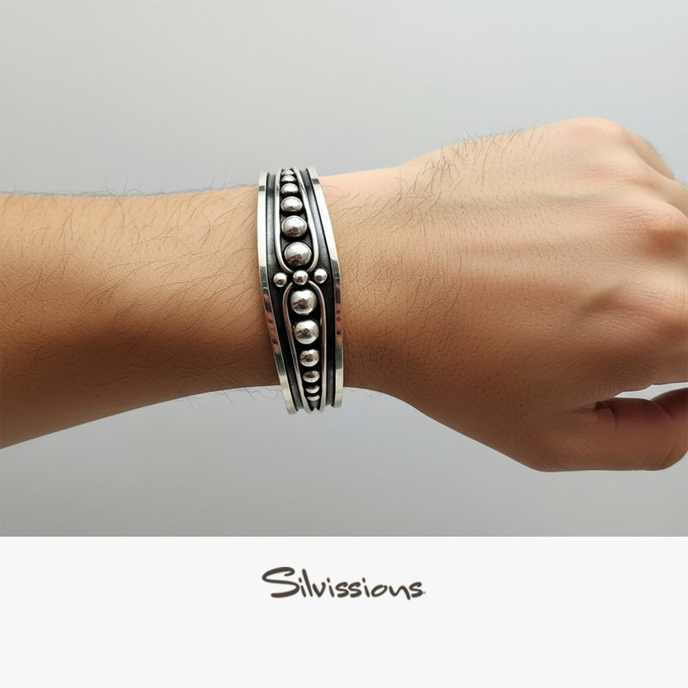 Silver bracelet on a wrist with 'Silvissions' branding