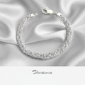 Silver bracelet on a beige background with 'Silvissions' branding.