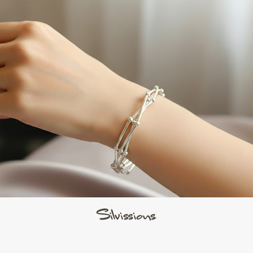 Silver bracelet on a wrist with a blurred background, featuring the brand 'Silvissions'.