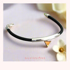 Black rubberr bracelet with silver and gold accents on a light background, featuring the brand 'Silvissions'.