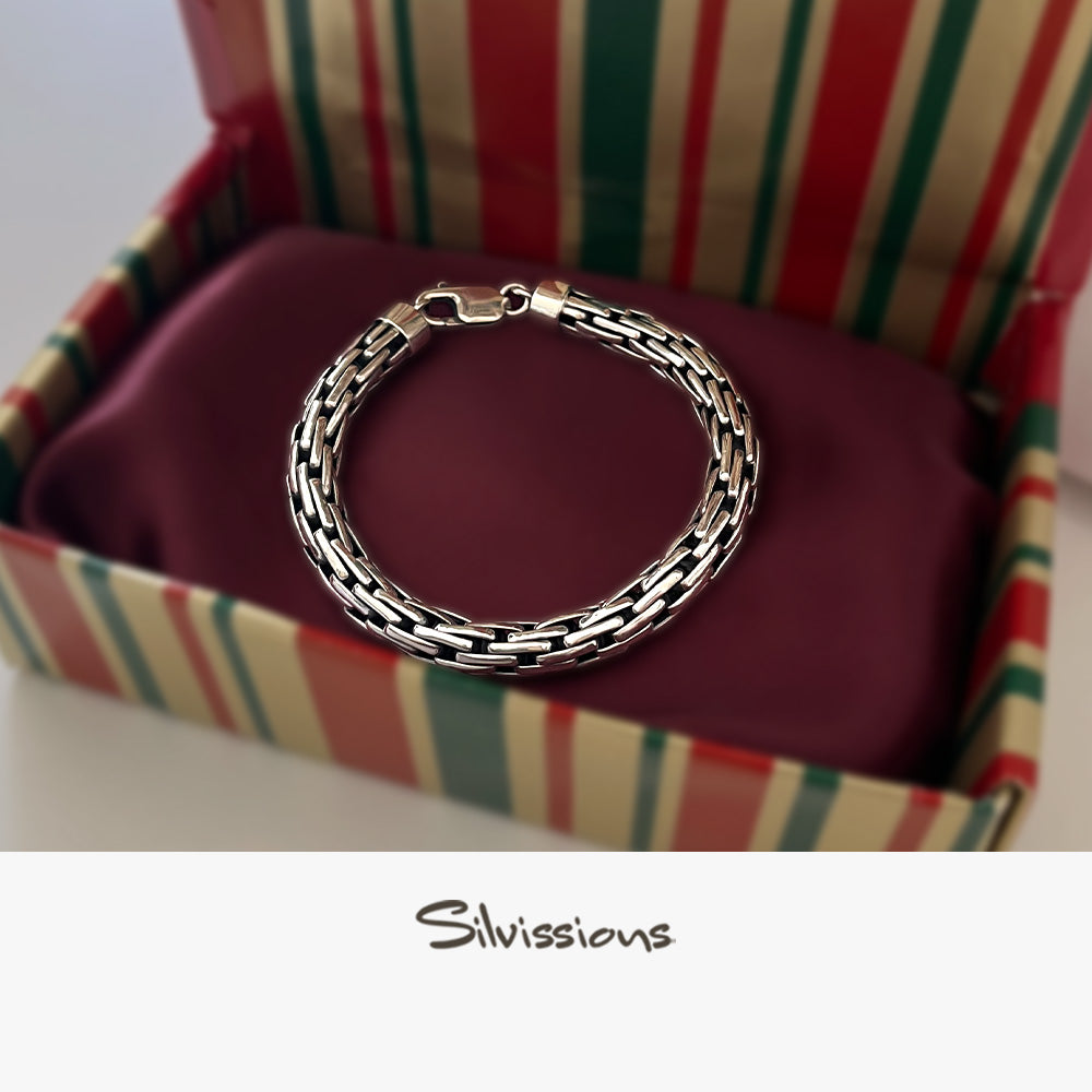 Silver bracelet in a colorful striped box with 'Silvissions' branding.