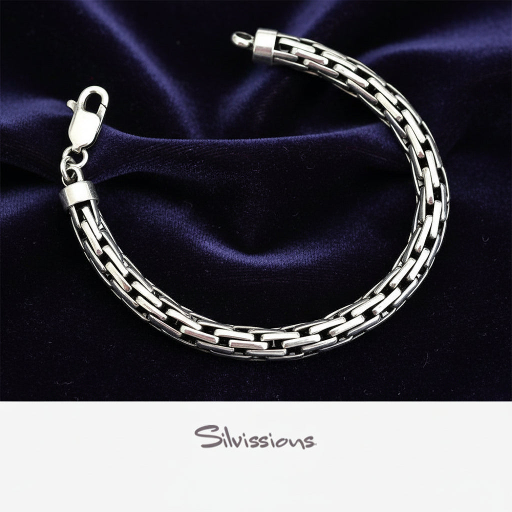 Silver bracelet on a dark purple fabric background with 'Silvissions' branding.