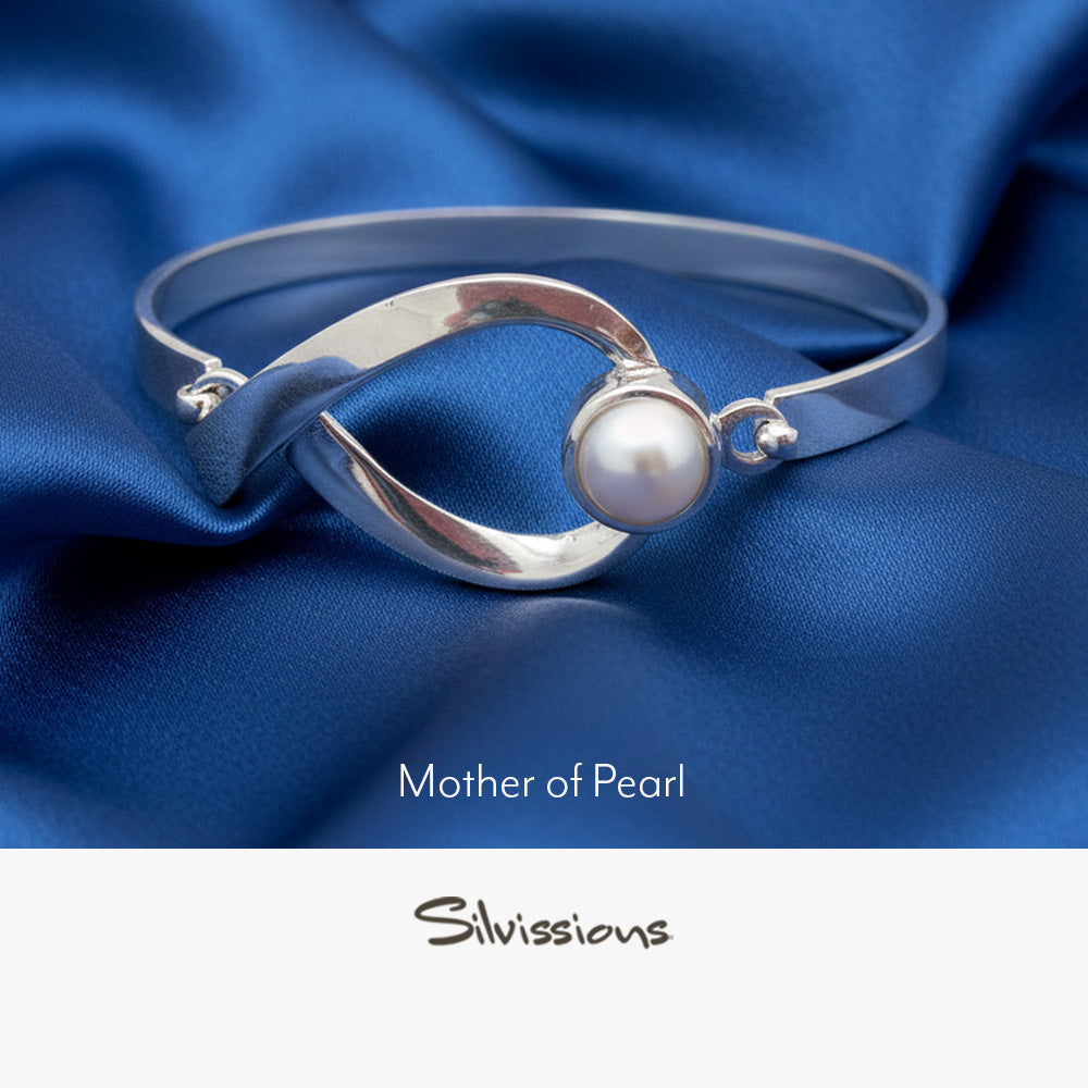 Silver bracelet with a mother of pearl gemstone on a neutral background, branded 'Silvissions'.