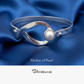 Silver bracelet with a mother of pearl gemstone on a neutral background, branded 'Silvissions'.