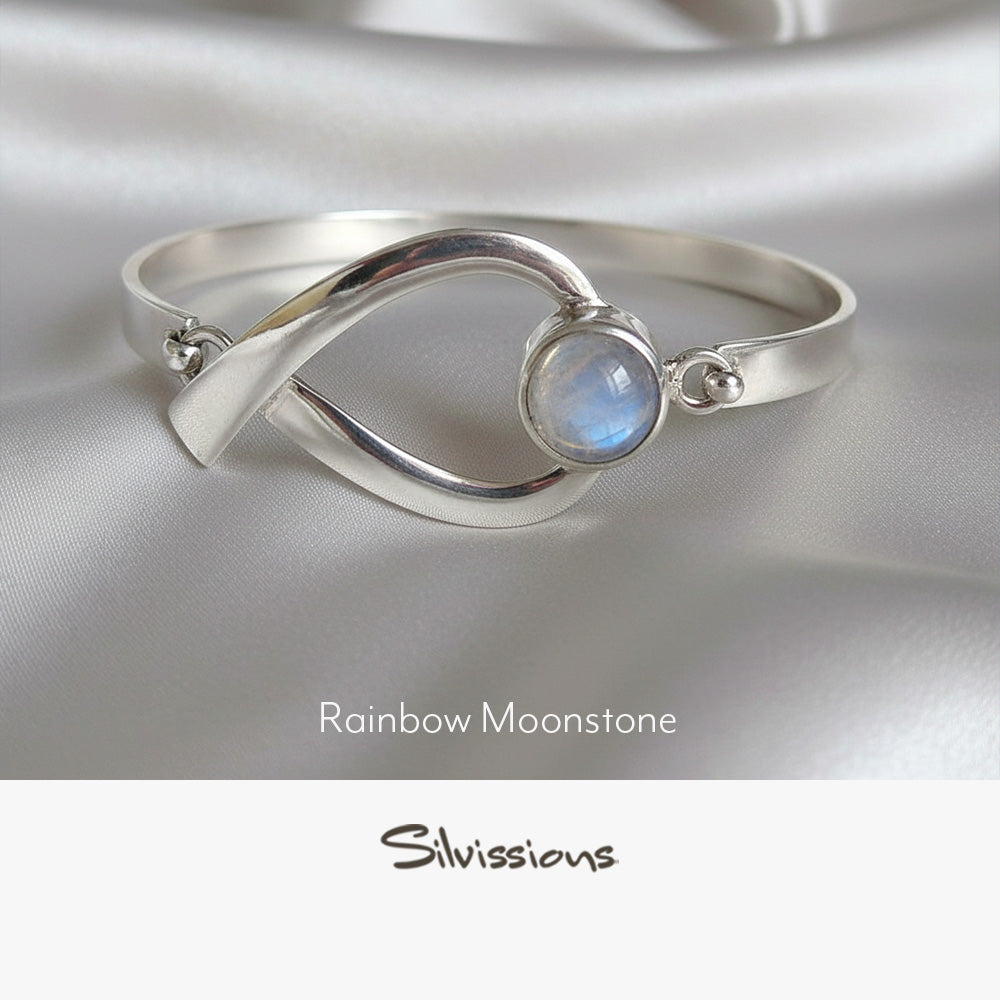 Silver bracelet with rainbow moonstone on a satin background, featuring the brand 'Silvissions'.