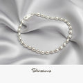 Silver bracelet on a silver satin background with 'Silvissions' branding.