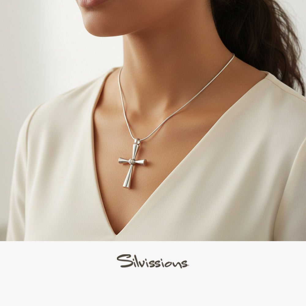 Silver cross necklace on a model with 'Silvissions' branding.