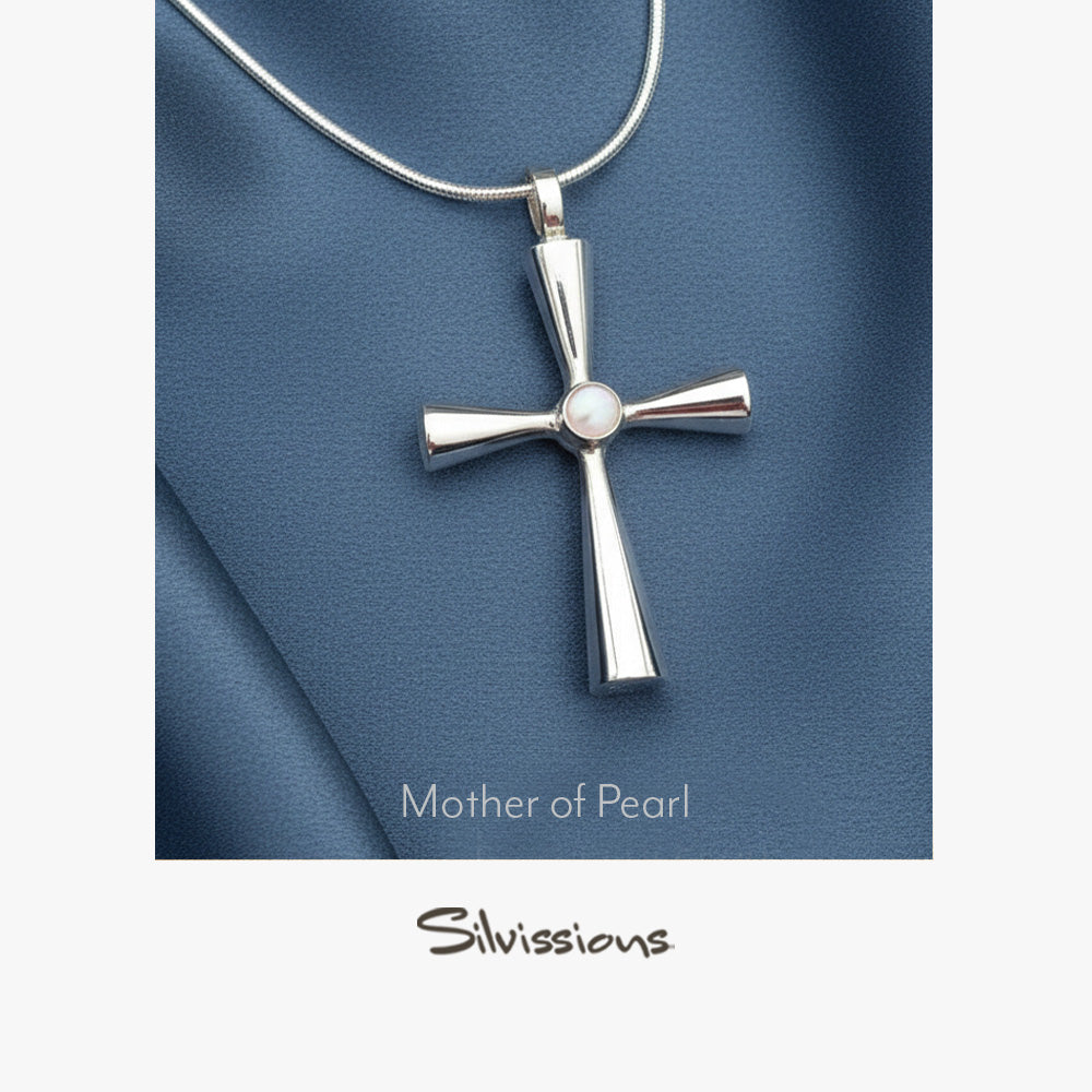 Silver cross pendant with 'Mother of Pearl' and 'Silvissions' text on a blue fabric background
