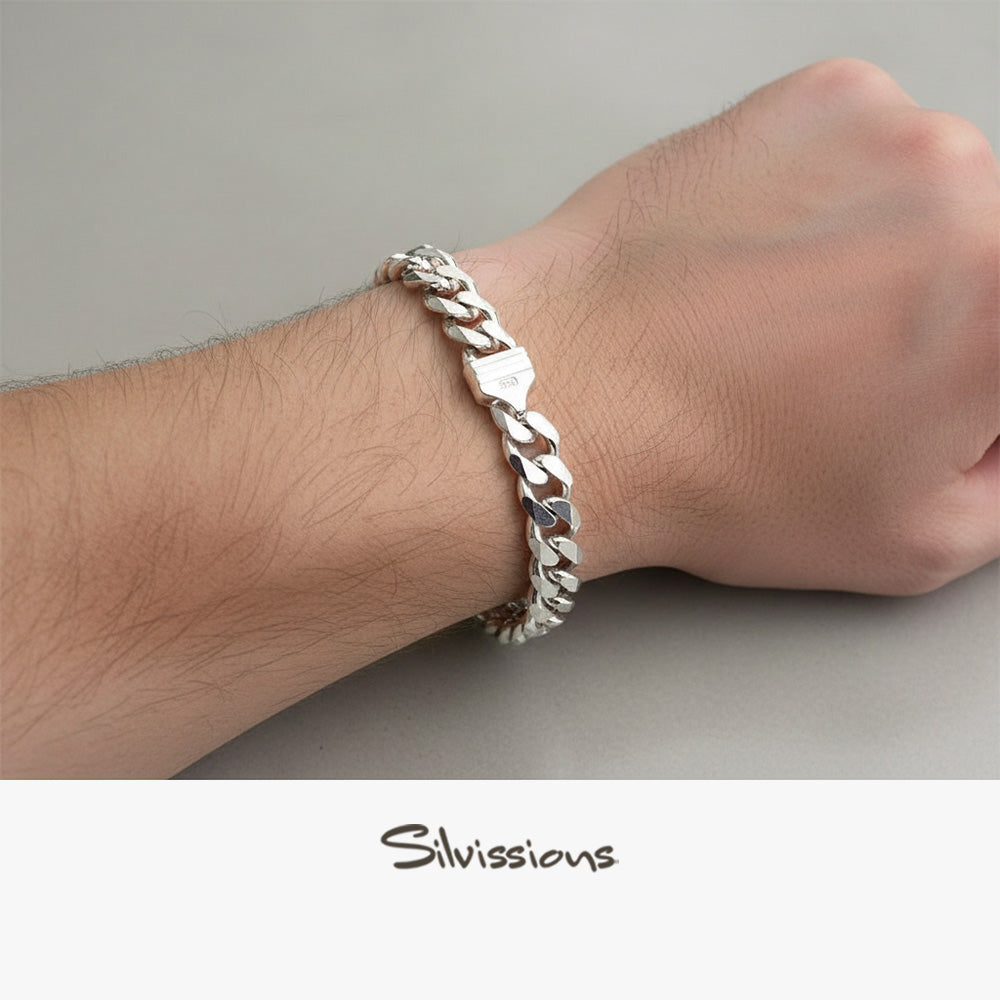 Silver cuban chain bracelet on a wrist with 'Silvissions' branding.
