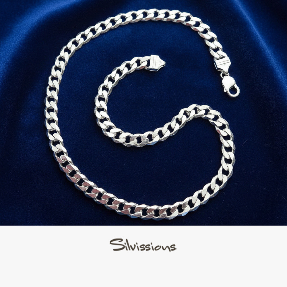 Silver cuban chain necklace on a blue satin background with 'Silvissions' branding.