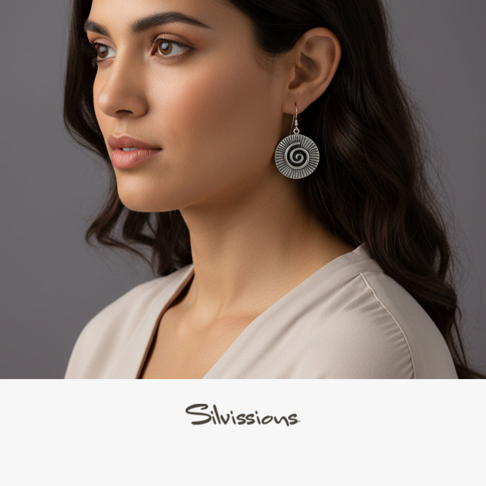 Woman wearing a spiral earring with 'Silvissions' branding