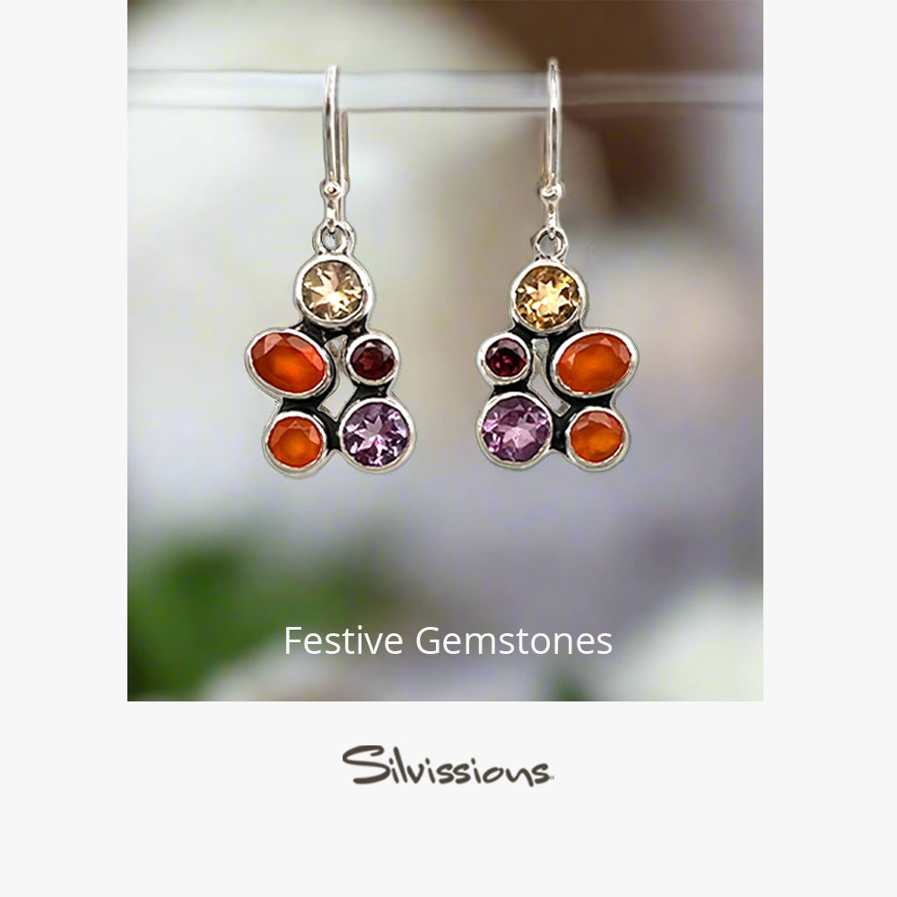 Festive gemstone earrings with 'Silvissions' branding on a gray background