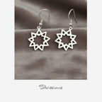 Silver star-shaped earrings on a textured surface with 'Silvissions' branding.