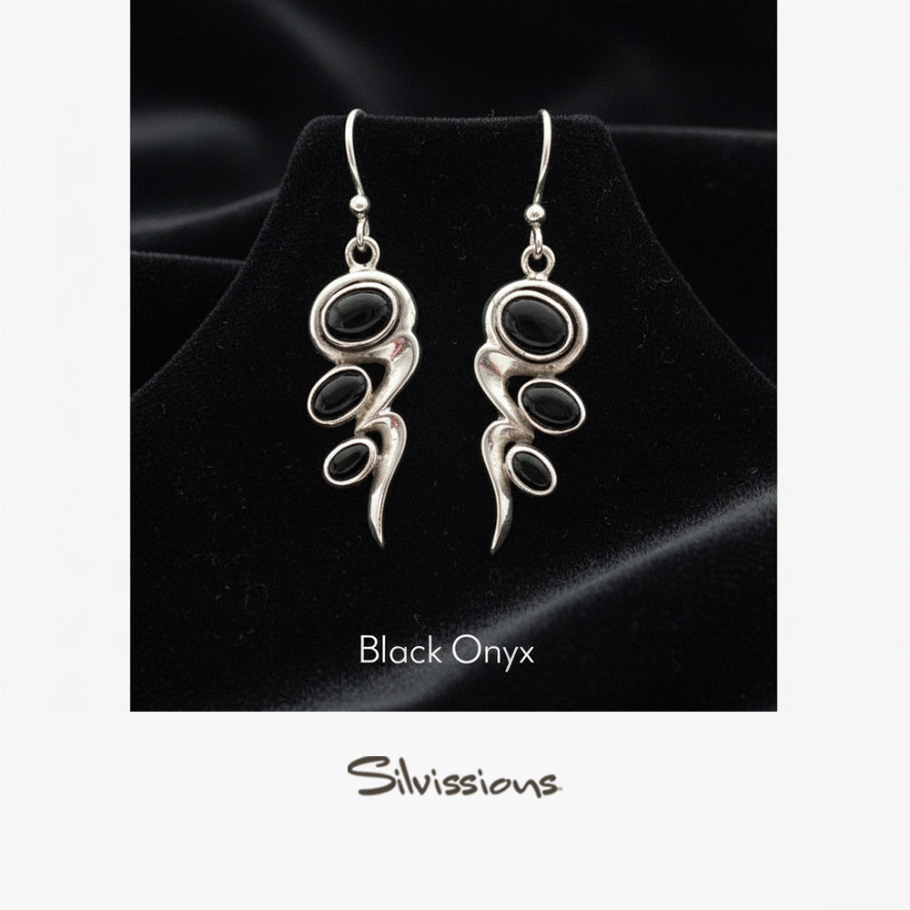 Black onyx earrings with silver designs on a black background, branded 'Silvissions'.