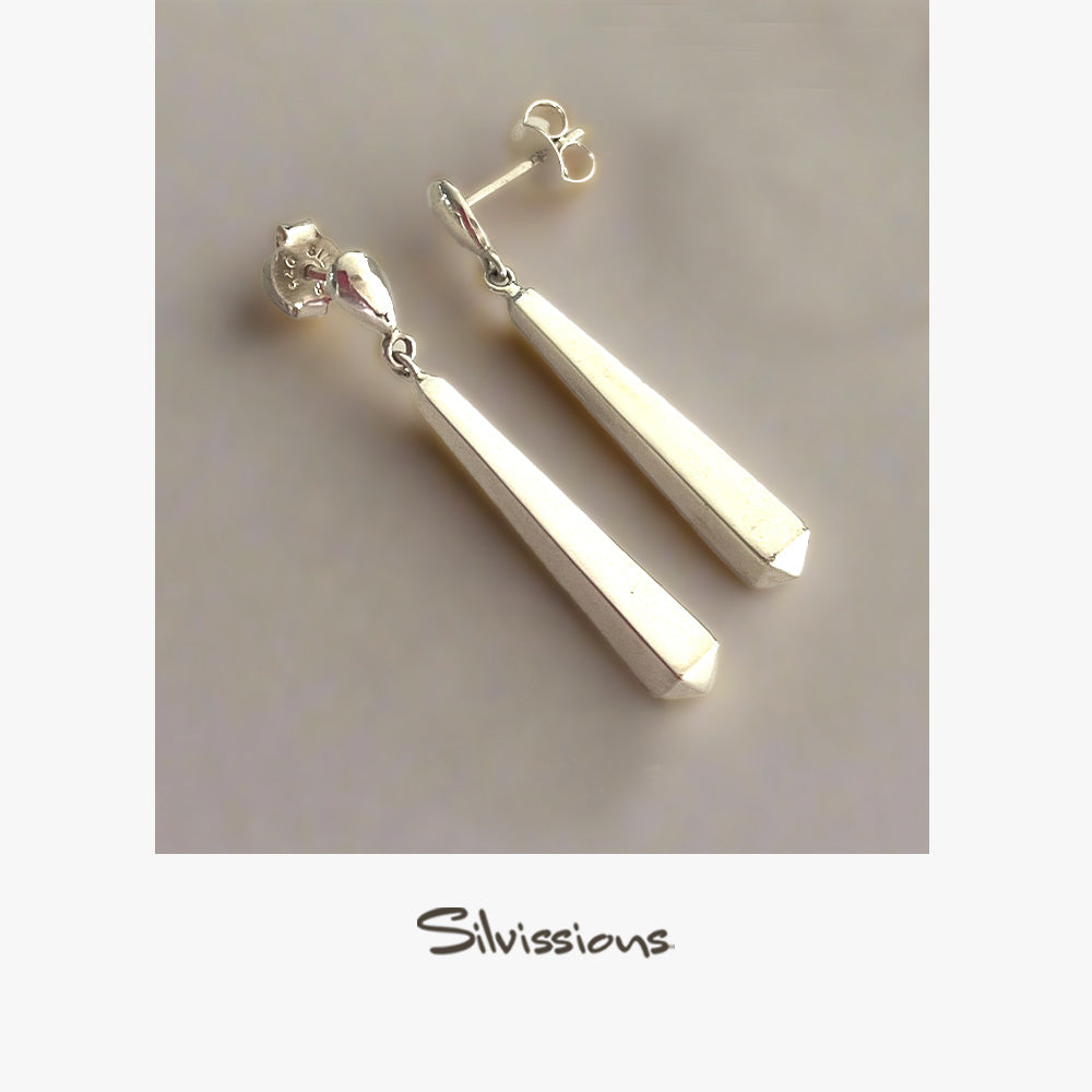 Pair of silver bar earrings on a neutral background with 'Silvissions' branding.