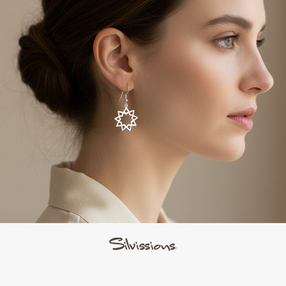 Close-up of a woman wearing star-shaped earrings with 'Silvissions' branding.
