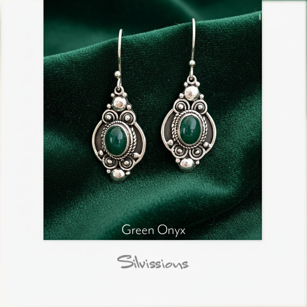 Green onyx earrings with silver detailing on a Silvissions branded card.