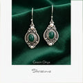 Green onyx earrings with silver detailing on a Silvissions branded card.