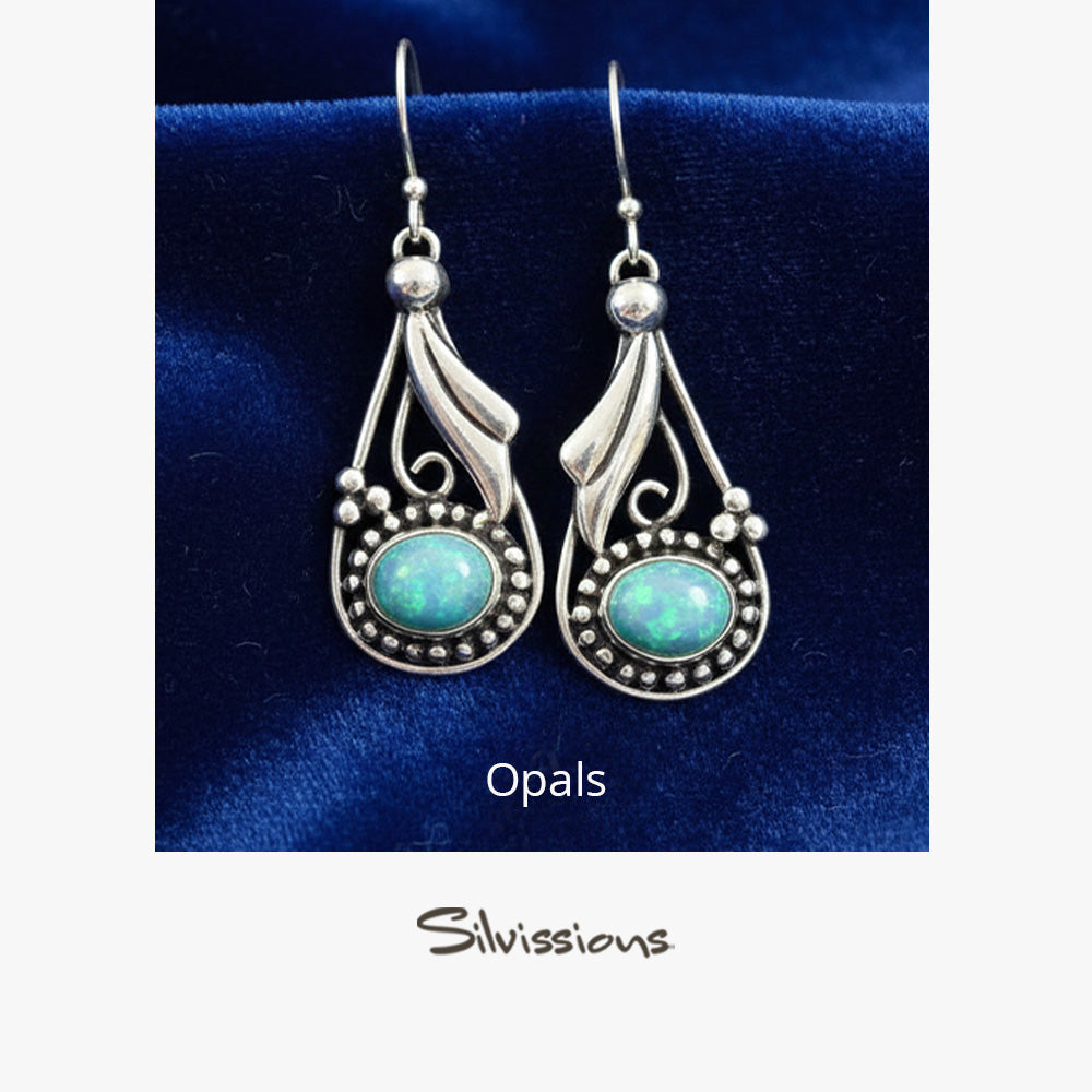 Pair of silver earrings with blue stones on a beige card, featuring the brand 'Silvissions'.