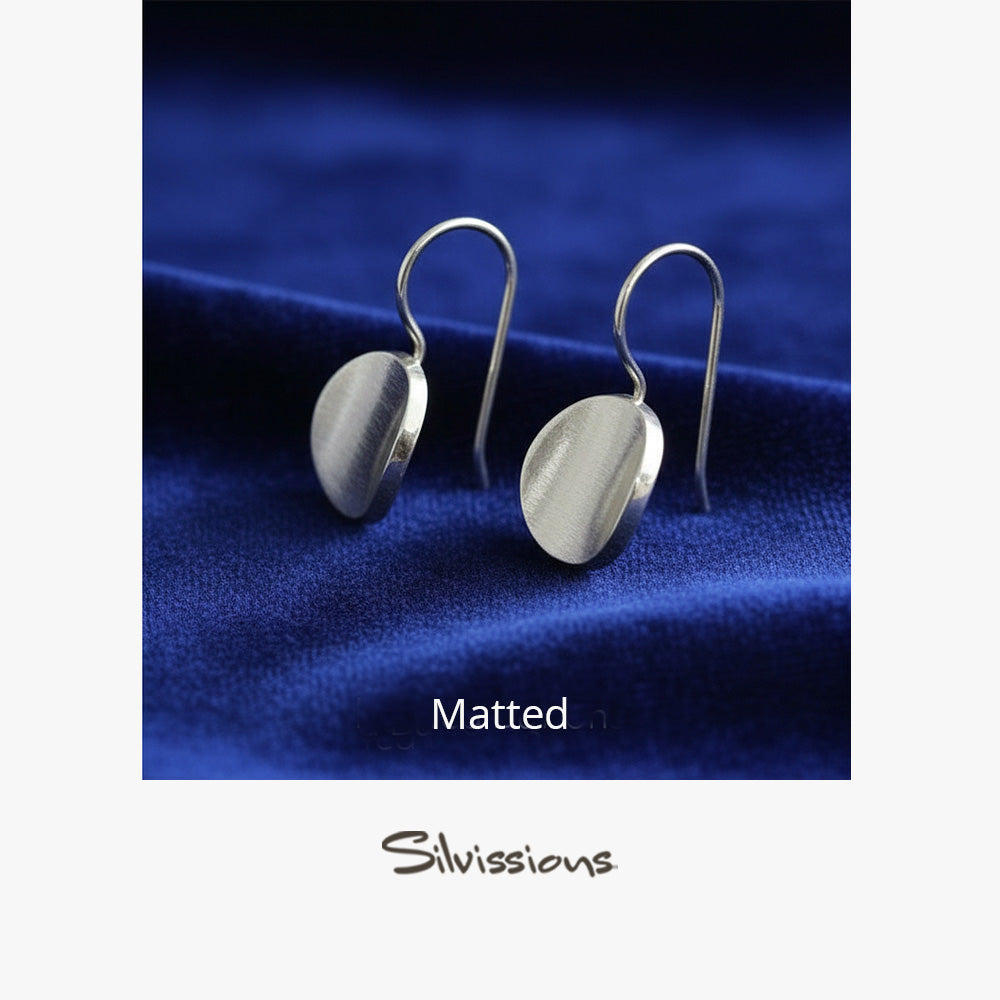 Sterling Silver matted drop earrings on a blue fabric background, branded 'Silvissions'.