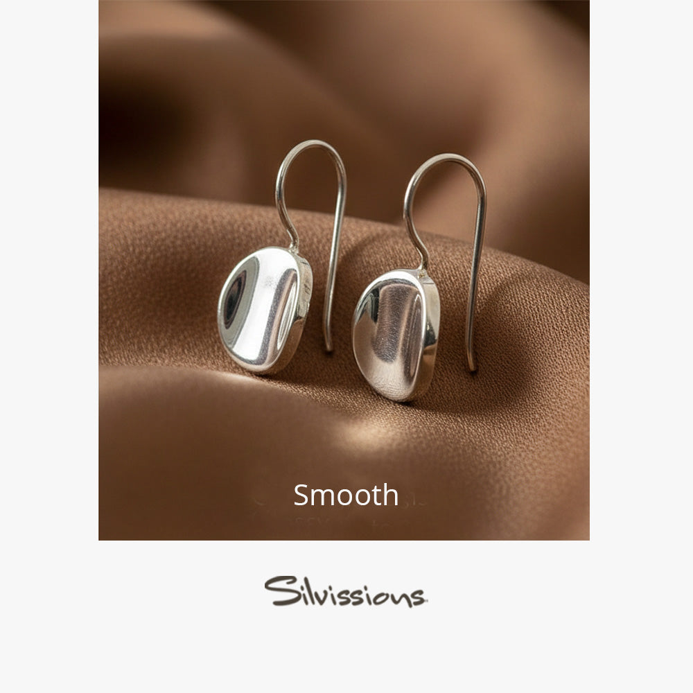 Sterling Silver drop earrings on a brown fabric background, featuring the brand 'Silvissions'.
