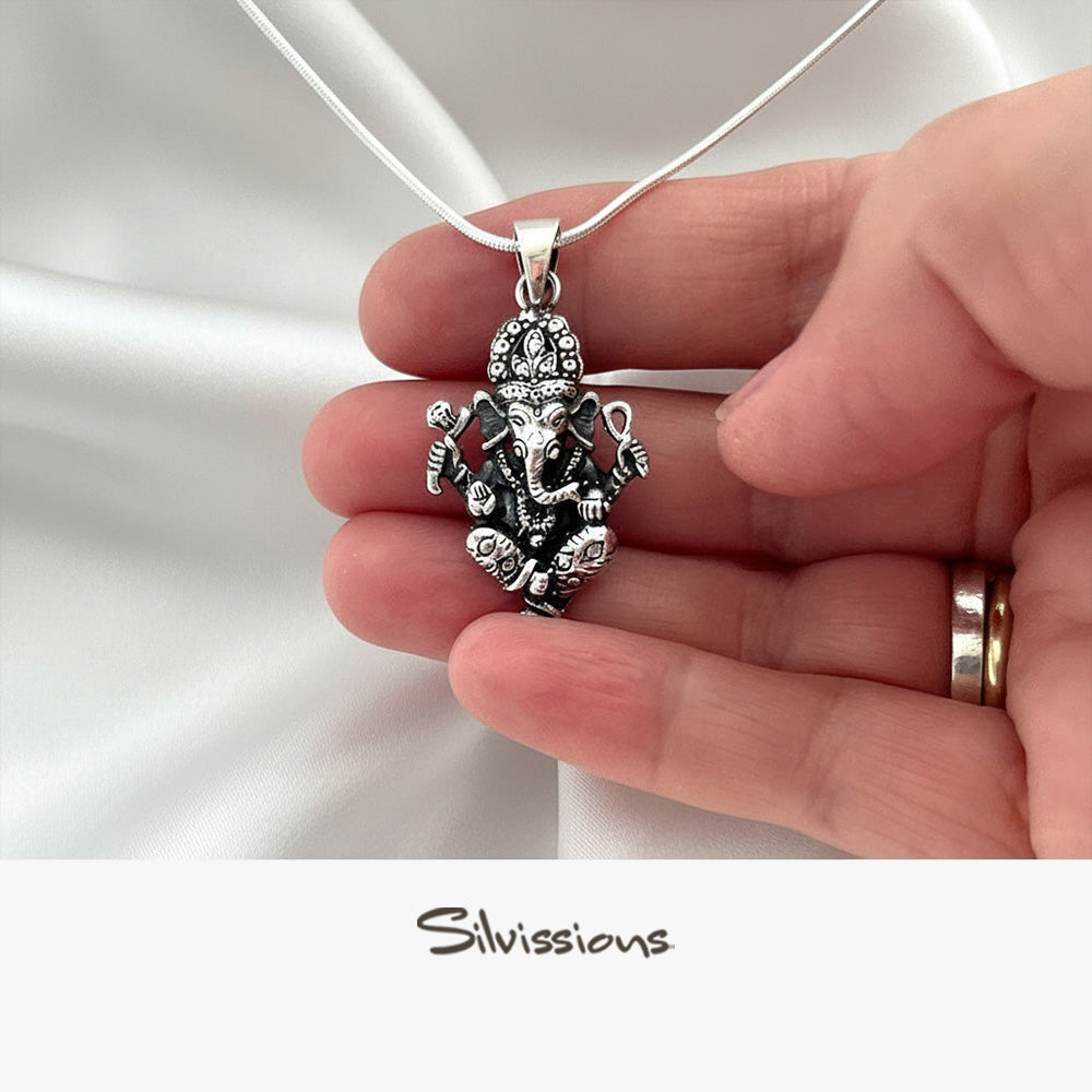 Silver pendant held in a hand with a white background, featuring the brand 'Silvissions'.