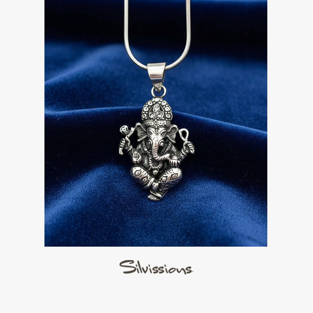 Silver Ganesha pendant necklace on a blue velvet background with 'Silvissions' branding.