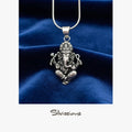 Silver Ganesha pendant necklace on a blue velvet background with 'Silvissions' branding.