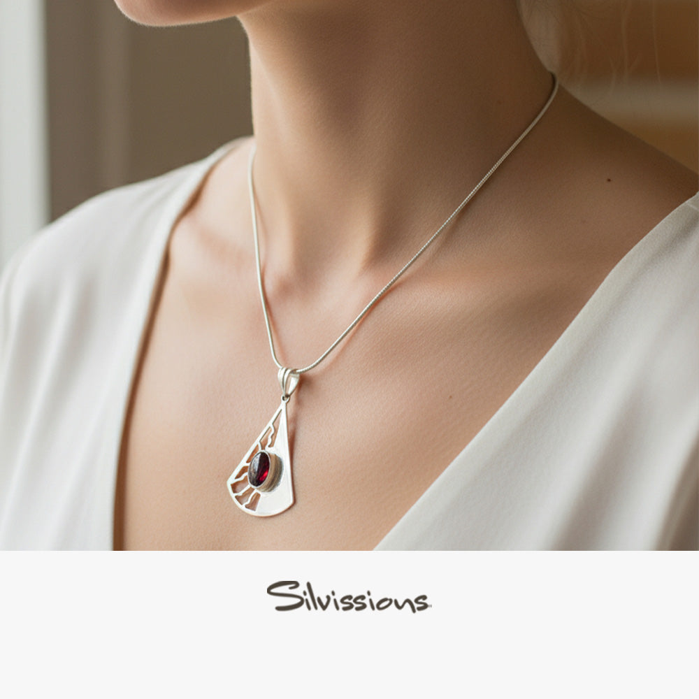 Silver necklace with a pendant worn by a girl, brand 'Silvissions' visible