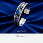 Silver bracelet with blue stones on a gray background, featuring the brand 'Silvissions'.