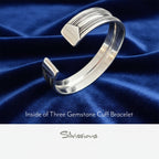 Silver cuff bracelet on blue satin fabric with 'Silvissions' branding.