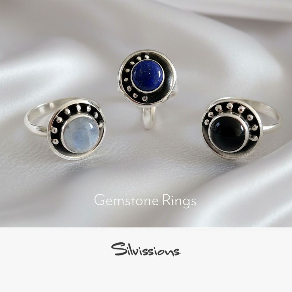 Three gemstone rings with different stones on a white background, branded 'Silvissions'.