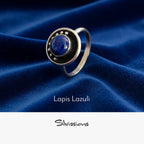 Silver ring with lapis lazuli stone on blue fabric, featuring the brand 'Silvissions'.