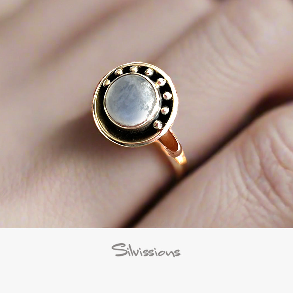 Sterling Silver  ring with a rainbow moonstone gemstone on a hand, branded 'Silvissions'.