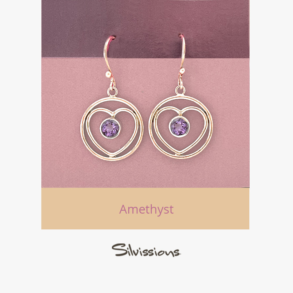 Heart-shaped earrings with pink gemstones on a pink and beige card, featuring the brand 'Silvissions'.