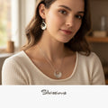 Woman wearing a necklace and earrings with 'Silvassions' branding.