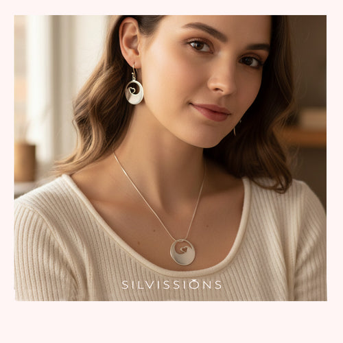 Woman wearing a necklace and earrings with 'Silvassions' branding.