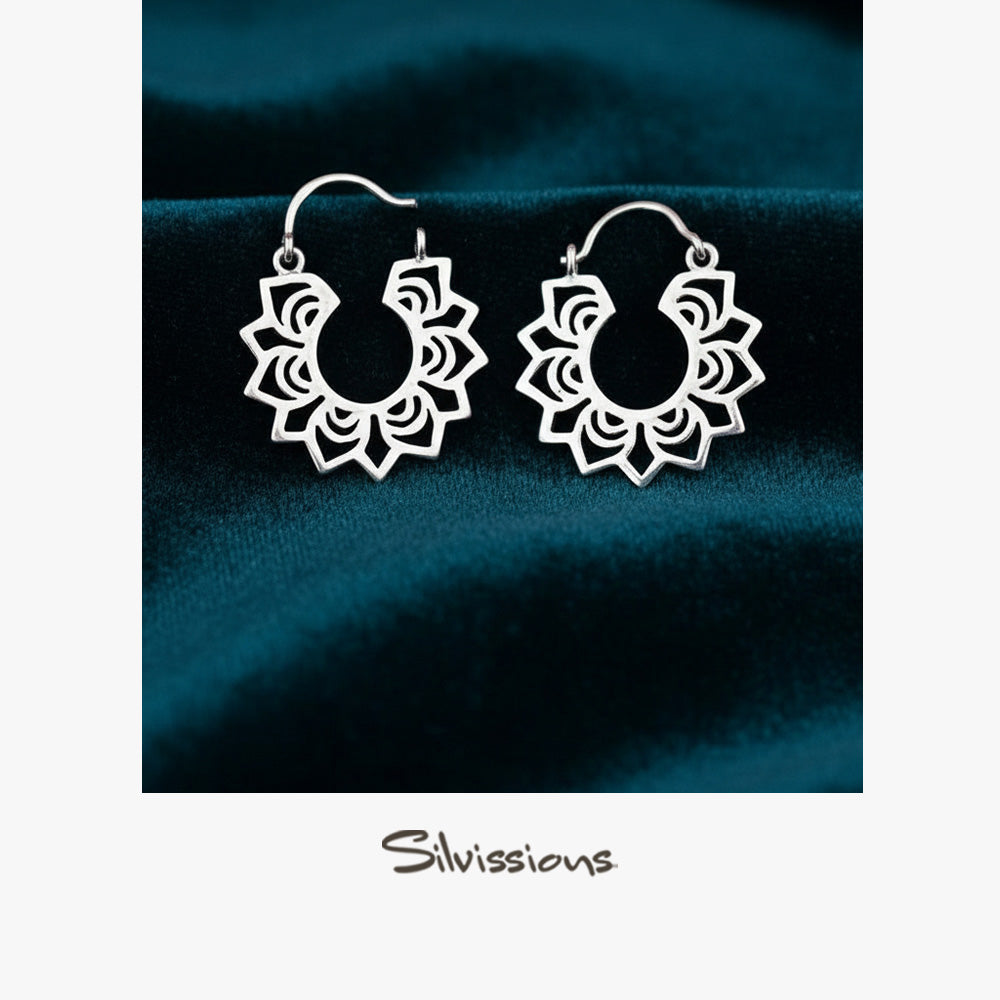 Silver hoop earrings on a dark blue fabric background with 'Silvissions' branding.
